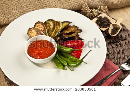 grilled vegetables,fried eggplants with fresh tomato isolated on white plate