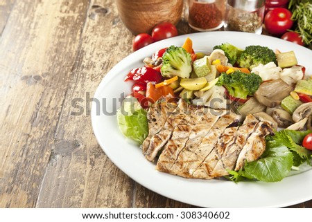Original fajita sizzling smoking hot served on plate and fresh vegetables on background
