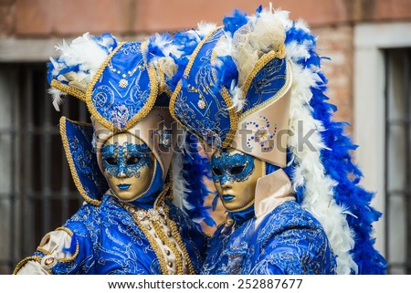 VENICE - FEB 13, 2015: An unidentified masked person in costume in St. Mark\'s Square during the Carnival of Venice on February 13, 2015. The 2015 carnival was held from February 7 Th to February 17Th