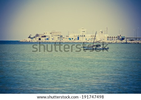 Landscape in Tunisia: boats in the sea bay. Filtered image:cross processed vintage effect