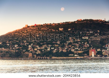 Old fortress on the sea and the moon. Mediterranean sea,  Alanya, Turkey.