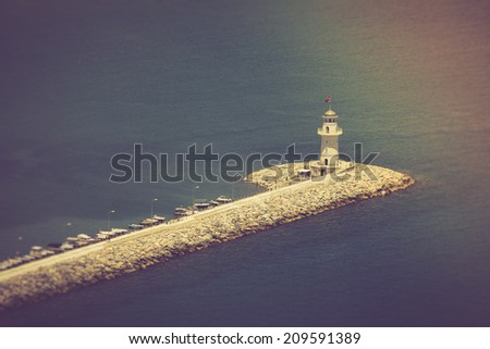 Lighthouse in port Alanya, Turkey. Mediterranean sea. Filtered image:cross processed vintage effect.