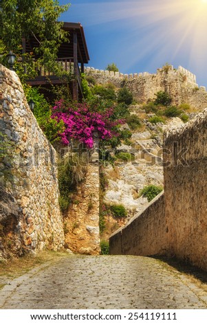 The old fortress in Alanya: paths around the fortress terrain in sunshine. Turkey. Filtered image: colorful and soft effect.