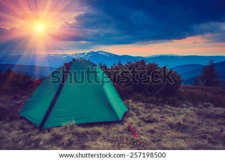 Landscape at tent camping in the mountains. Filtered image: vintage effect.