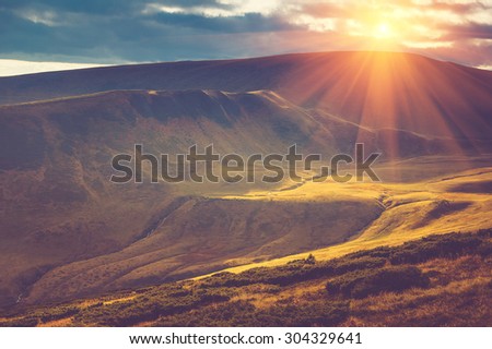 Scenic view of mountains, autumn landscape with colorful hills at sunset.Filtered image:cross processed vintage effect.