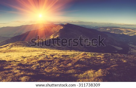 Scenic view of mountains, autumn landscape with colorful hills at sunset.Filtered image:cross processed vintage effect.