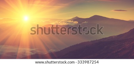 Panoramic view of mountains, autumn landscape with foggy hills at sunrise. Filtered image:cross processed vintage effect.