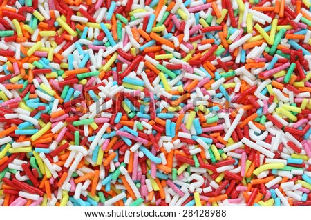 Close-up of many small decorative pieces of colorful sugar sweets used to decorate cookies