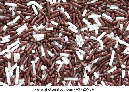 Background of brown and white sprinkles, jimmies for cake decoration or ice cream topping