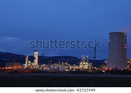 View of large petrochemical factory in early night light with shining lights