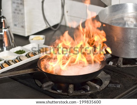 Cooking with flame in a frying pan