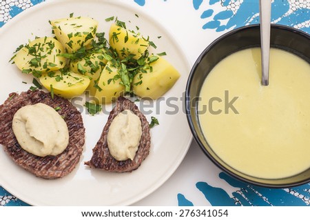 Healthy lunch time: asparagus cream and homemade hamburger beef with boiled potatoes