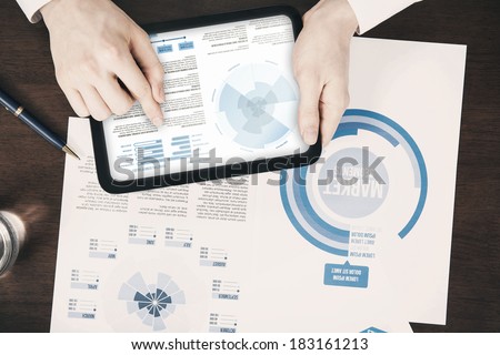 Close-up of business documents concept pointing digital tablet