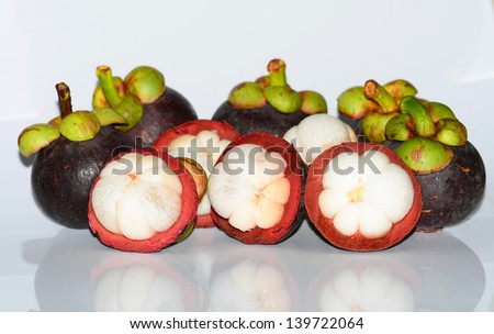 isolate mangosteen on white background, the tropical purple fruit in Thailand.