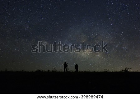 Women look into space and the Milky way. Long exposure photograph