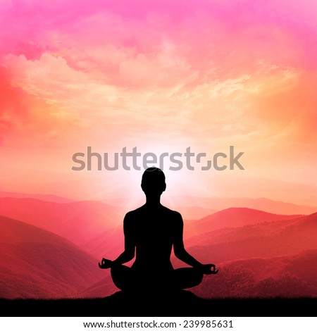 Yoga silhouette in the mountain and majestic sunrise