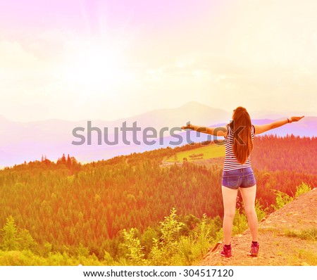 Free happy woman enjoying nature in the mountains. Outdoor.