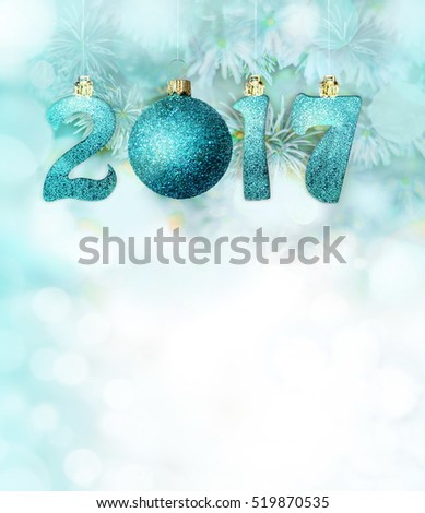 Set of blue shiny digits and ball on a snowy fir branches. New year 2017 background. Christmas.