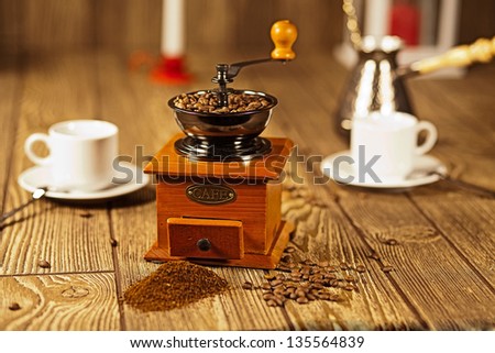 coffee grinder with coffee on the table