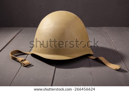Military green helmet on the table