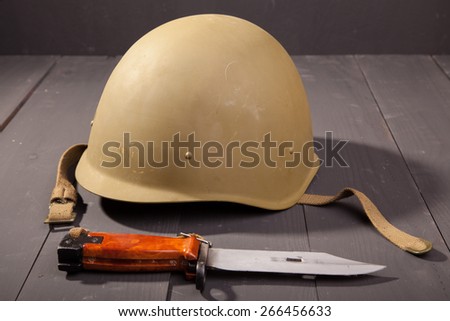 Military green helmet on the table