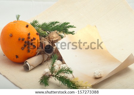 orange with cloves and walnuts and golden paper