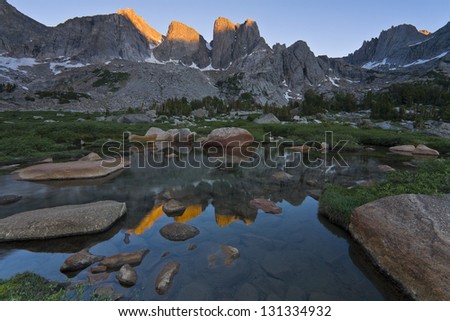 First Light: Cirque of the Towers. The first rays of the rising sun hit the massive granite towers of the Wind River Range in Wyoming.