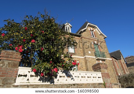 A little house with trees and flowers in a small town of  Dol-de-Bretagne, France
