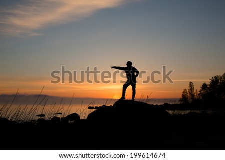 Silhouette of man on a background of sunrise