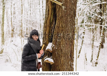 Girl with a book in the winter forest
