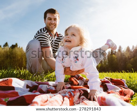 Father holding his daughter on hands. Dad and daughter having fun together