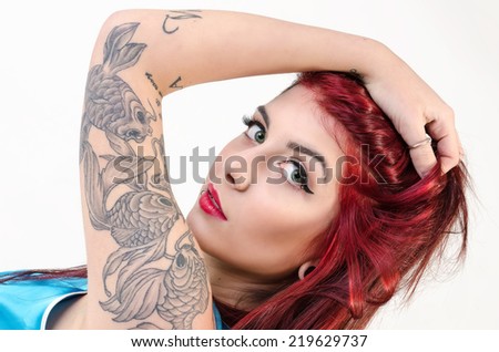 Beautiful tattooed Girl with red hair. tattoo