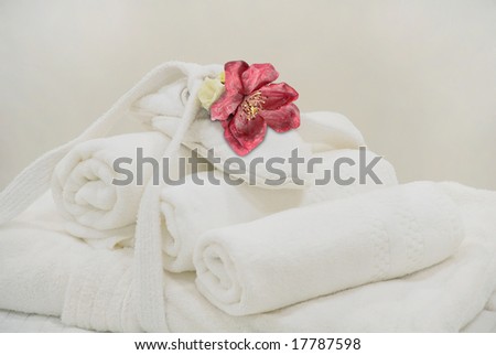 image of a high key pale white towel, flower and tones to give impression of pure and simple natural beauty and spa treatment ingredients