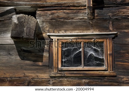 Swiss old wooden window with cobweb, excellent wooden texture