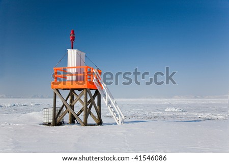 Amazing frost Sea landscape with Lighthouse of Spitsbergen in the Arctic North Pole region.