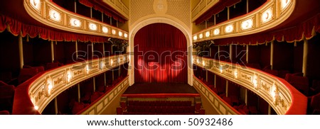 Classical Theater with Red stage curtain with arch lights and shadows.