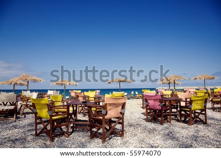 View of restaurant, chairs and umbrella on the beach