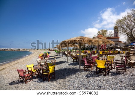 View of restaurant, chairs and umbrella on the beach