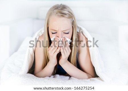 Beautiful Young Woman  blowing her nose with handkerchief