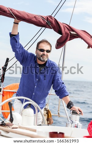 Skipper, Mature man driving a Sailboat