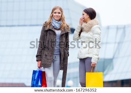 Two girlfriends with shopping bags