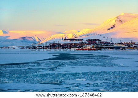 Glacier With Small Iceberg At The Arctic North Pole, Svalbard. In Background Is Longyearbyen City, Sunset Light
