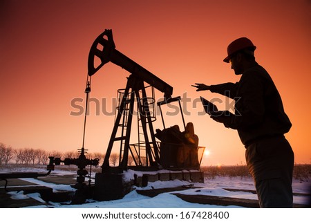 Oil Drill, Field Pumpjack Silhouette With Setting Sun And Worker
