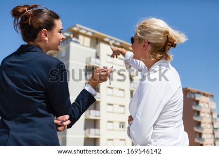 Real Estate Agent Shows To The Beautiful Young Woman Her New Home.