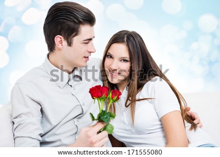 Man giving red roses to a woman