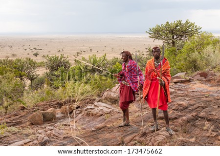 Two Masai warriors standing and looking away, soft focus