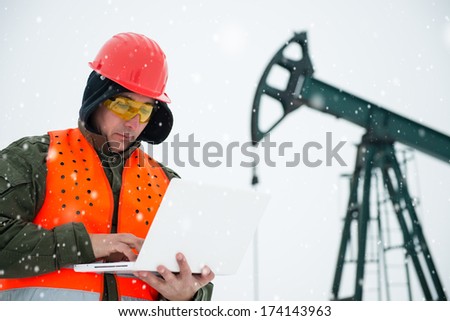 Oil Drill, field pump jack with snow storm and worker See more images and video from this series and Refinery series.