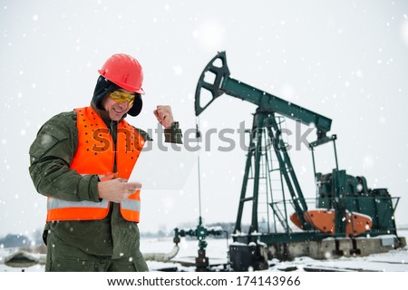 Oil Drill, field pump jack with snow storm and worker. See more images and video from this series and Refinery series.