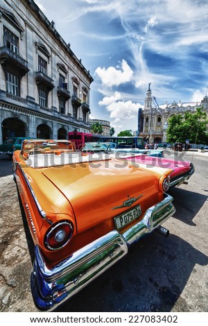 HAVANA, CUBA - OCTOBER 8, 2014: Old classic American cars in street city Havana. Before a new law issued on October 2011, Cubans could only trade cars that were on the road before 1959. Wide angle.