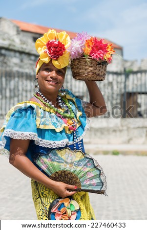 Attractive woman in traditional Cuban clothing posing at the street of Havana, Cuba